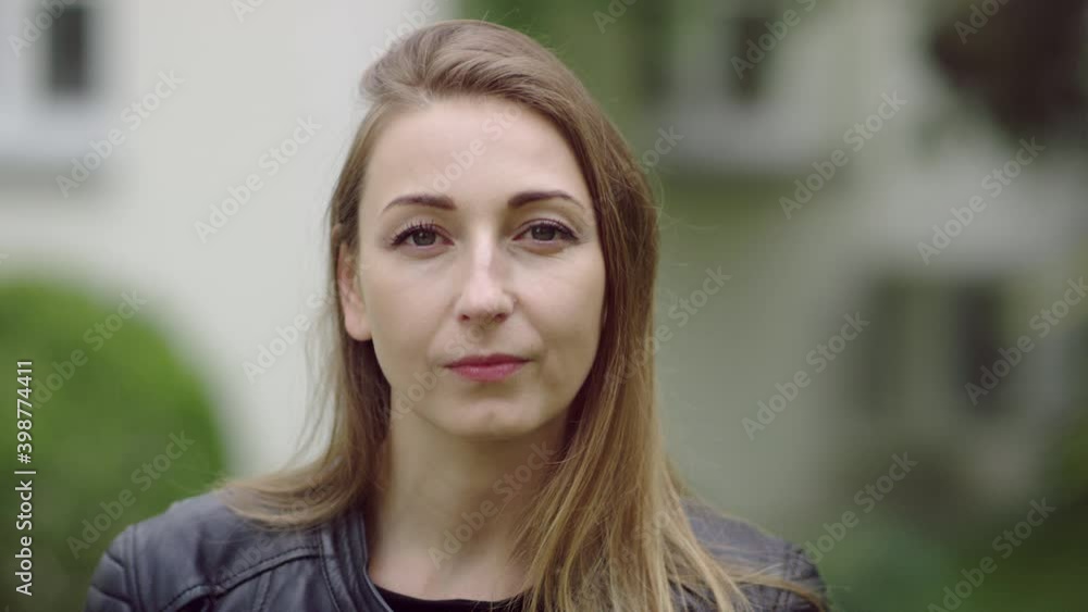 Face of mid-thirties blonde woman in the garden who is turning left and look at the camera. Face of mid-thirties blonde woman in the garden who is turning left and look at the camera.
