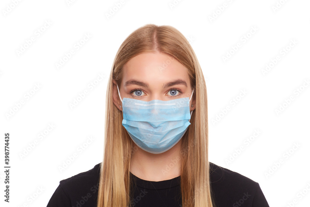 Girl in a medical mask protecting from viruses and air pollution Girl in a medical mask protecting from viruses and air pollution