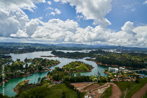 View of Guatape from the top of El Penon onto the artificial lake with its turquoise water and lagoons © Jens