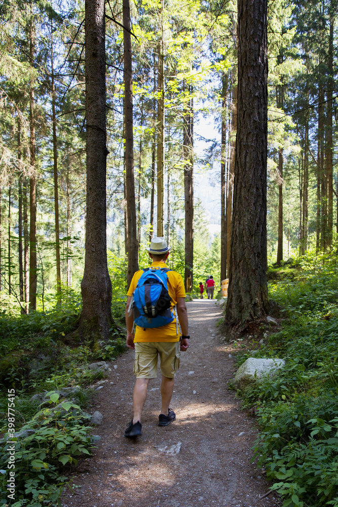 Obraz premium Tourist goes trekking on the Franciscan Way that leads to the Riva waterfalls