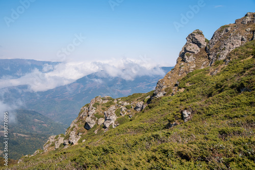 View from the top of Babin zub (The Grandmather's tooth) on Old mountain, which is the most beautiful peak of Stara planina ( Balkan mountains).The impressive and big striking rocks and dense plants. photo