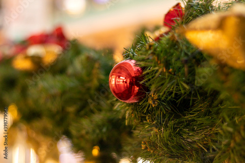 Shiny beautifal Christmas red ball hanging on pine branches. Selective focus. Top view. Blurred effect. Christmas concept. photo