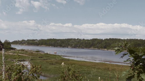 A calm summer day near the ocean with boat and inlet