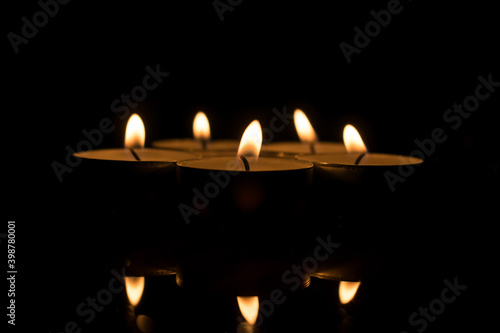 Group of candles. Candles lit to commemorate. Candles reflected in the water