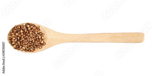 Buckwheat pile in wooden spoon isolated on white background, top view
