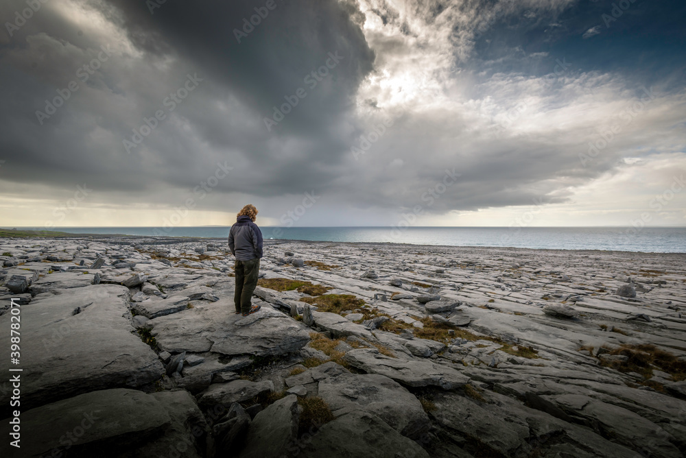 Man Standing on Limestone Beach at Black Head Ireland