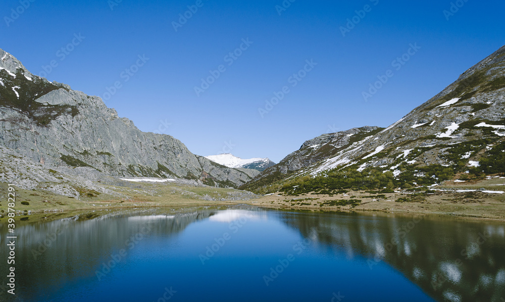 Lake Isoba, Leon. Spain. Mountain landscape with lake and snowy mountains.