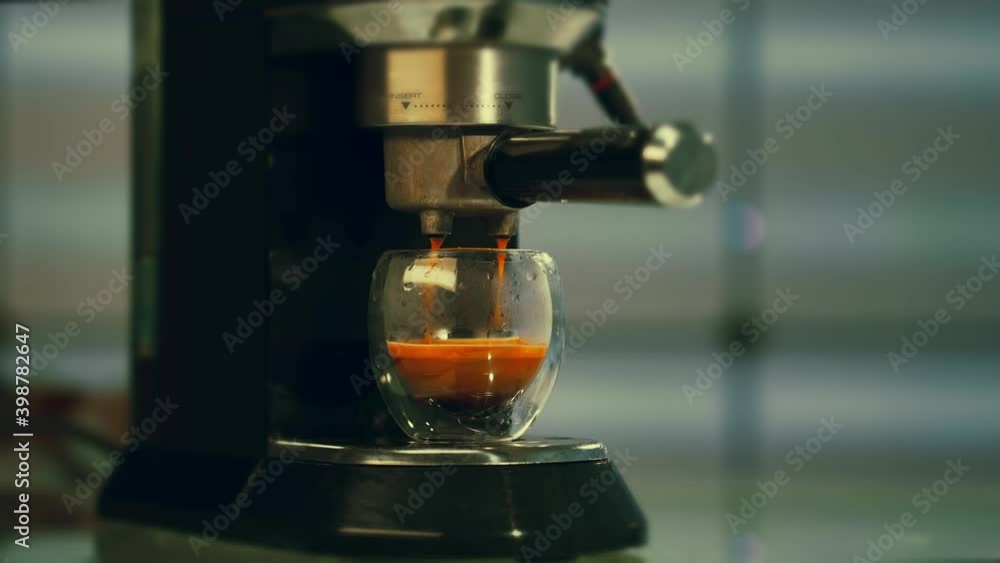 The coffee maker makes espresso coffee. Slow Motion video The coffee maker makes espresso coffee. Slow Motion video