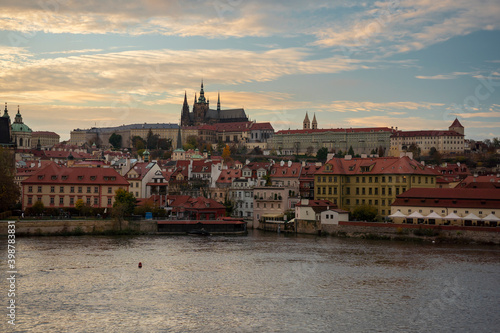 old prague castle and charles bridge and st. vita church lights from street lights are reflected on the surface of the vltava river in the center of prague at night in the czech republic