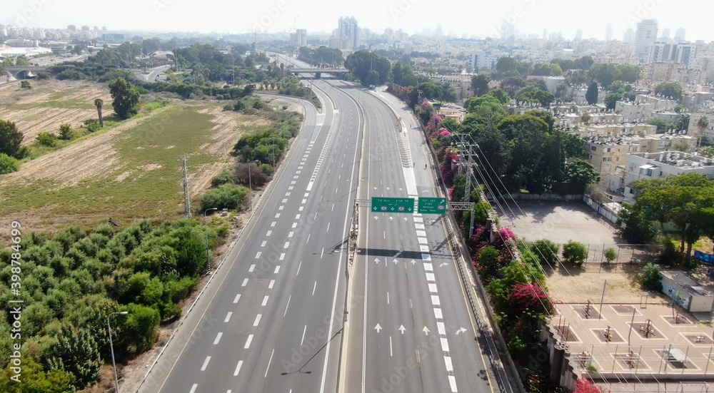 Fototapeta premium Netanya, Israel from a bird's eye view. Top-down view of the city during the Yom Kippur holiday, when all highways and roads are empty. Cars are not allowed to drive on this day