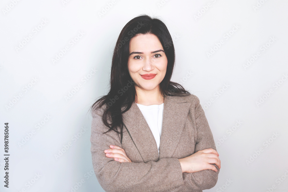 Happy young business woman posing isolated over grey wall background. Happy young business woman posing isolated over grey wall background.