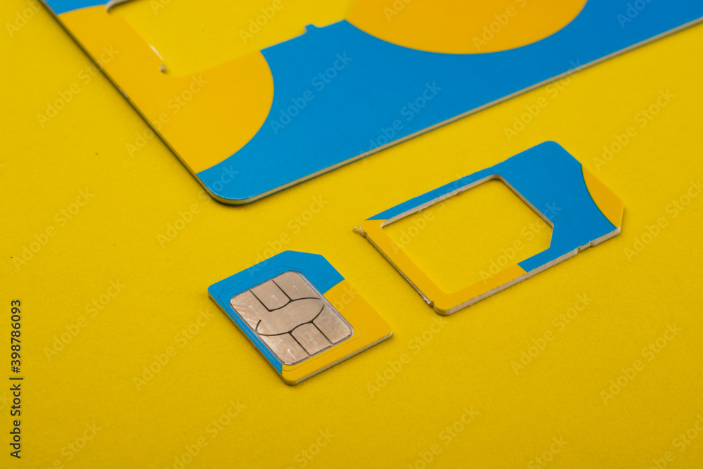 Obraz premium Sim card on a yellow background.