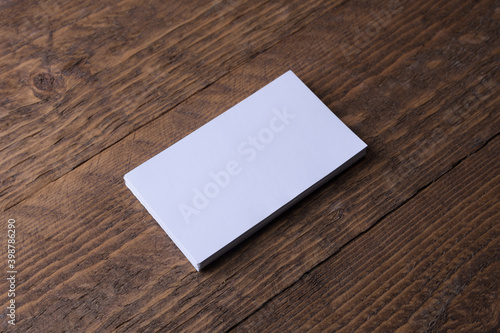Business card blank on wooden background. Corporate Stationery, Branding Mock-up. Creative designer desk. Flat lay. Copy space for text. Template for ID.