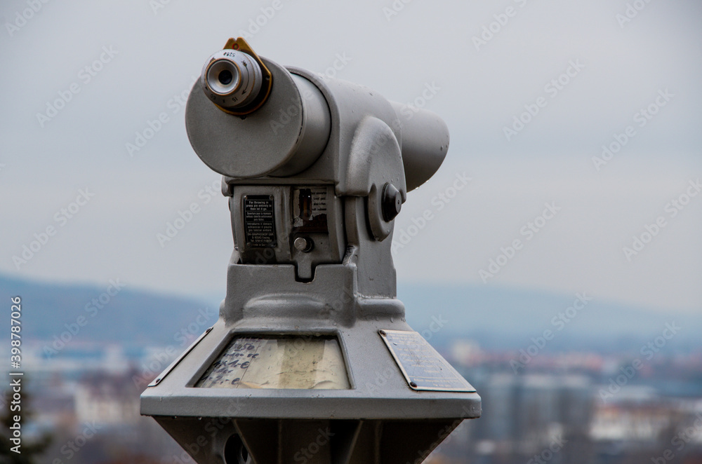 Grey Monocular in front of grey sky. High quality photo Grey Monocular in front of grey sky. High quality photo
