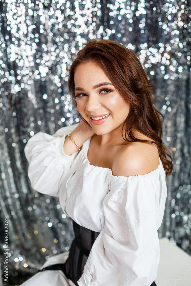 A beautiful young European lady wearing a black corset, white shirt. Sexy woman with professional makeup on her face. A beautiful young European lady wearing a black corset, white shirt. Sexy woman with professional makeup on her face.