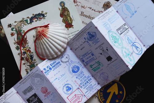 Personal belongings of a pilgrim - a pilgrim's passport with seals, a shell, a certificate of completion of the pilgrimage photo