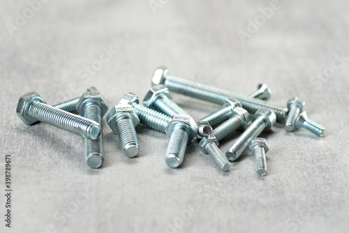 Metal bolts of different lengths on the table photo