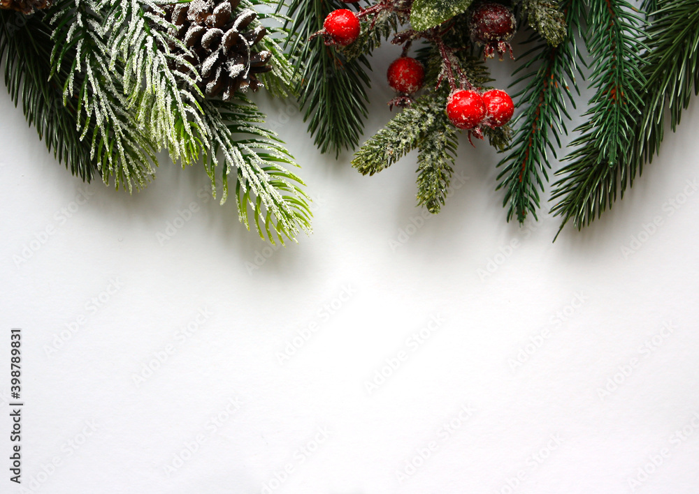 Christmas festive greeting card mock up with spruce branches, vibrant red berries and snow covered cones on white background. New Year postcard. Top view. Christmas festive greeting card mock up with spruce branches, vibrant red berries and snow covered cones on white background. New Year postcard. Top view.