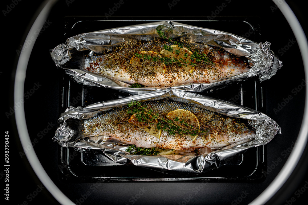 Fish European bass (sea bass)
fresh with lemon and Thymus on black background Fish European bass (sea bass)
fresh with lemon and Thymus on black background