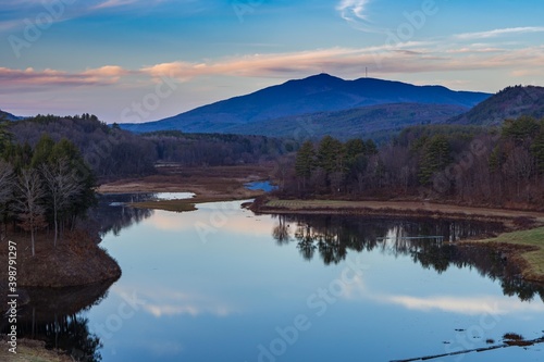 Mount Ascutney and sunset pink cloud reflections in the North Springfield Reservoir near Weathersfield, Vermont. 