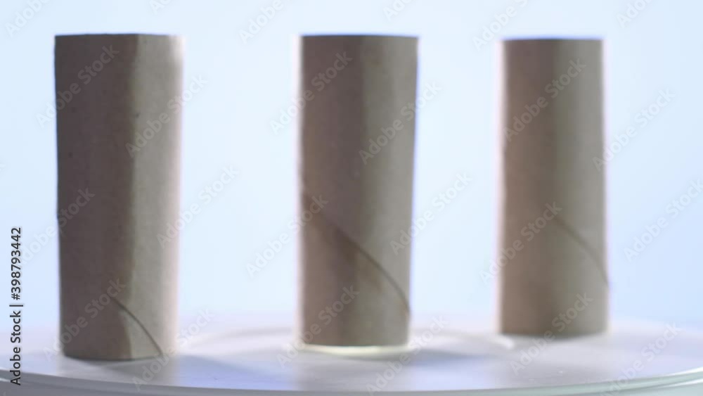 4k video of three cardboard rolls of the worn toilet paper spinning on a turntable. Selective focus 4k video of three cardboard rolls of the worn toilet paper spinning on a turntable. Selective focus