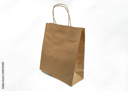 ecological kraft package with handles for shopping in store and delivery on isolated white background