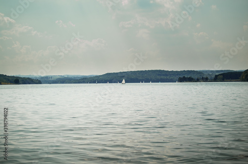 Sailboats sail on a small mountain lake in Pennsylvania © GenOne360