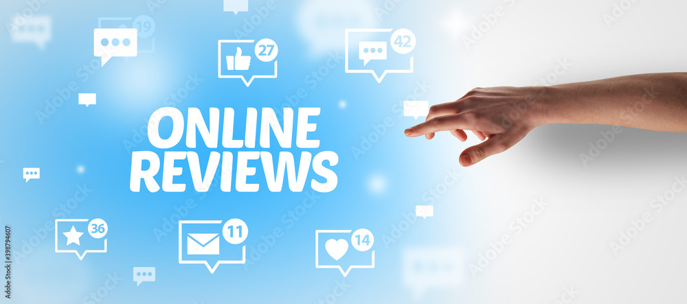Close-Up of cropped hand pointing at ONLINE REVIEWS inscription, social networking concept Close-Up of cropped hand pointing at ONLINE REVIEWS inscription, social networking concept