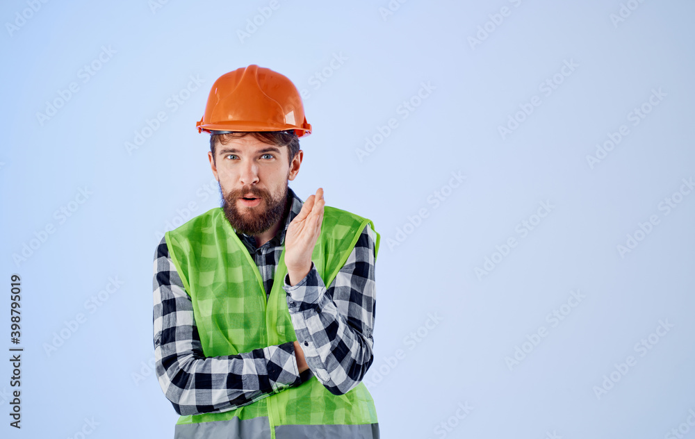 an architect in a helmet and a reflective vest gestures with his hands Copy Space an architect in a helmet and a reflective vest gestures with his hands Copy Space