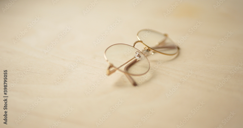close up eyeglasses on wooden background close up eyeglasses on wooden background