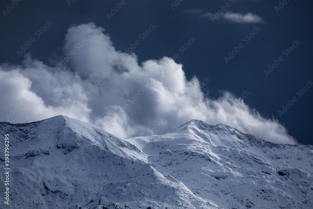 sunlight over snowy mountain peaks sunlight over snowy mountain peaks