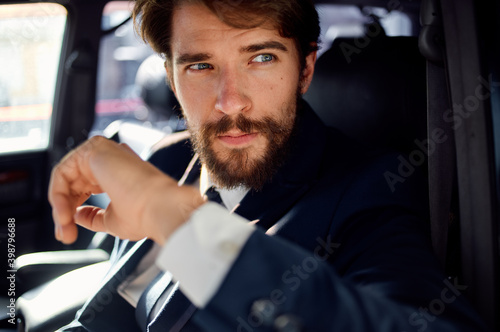 successful young man driving a car in a suit trip lifestyle
