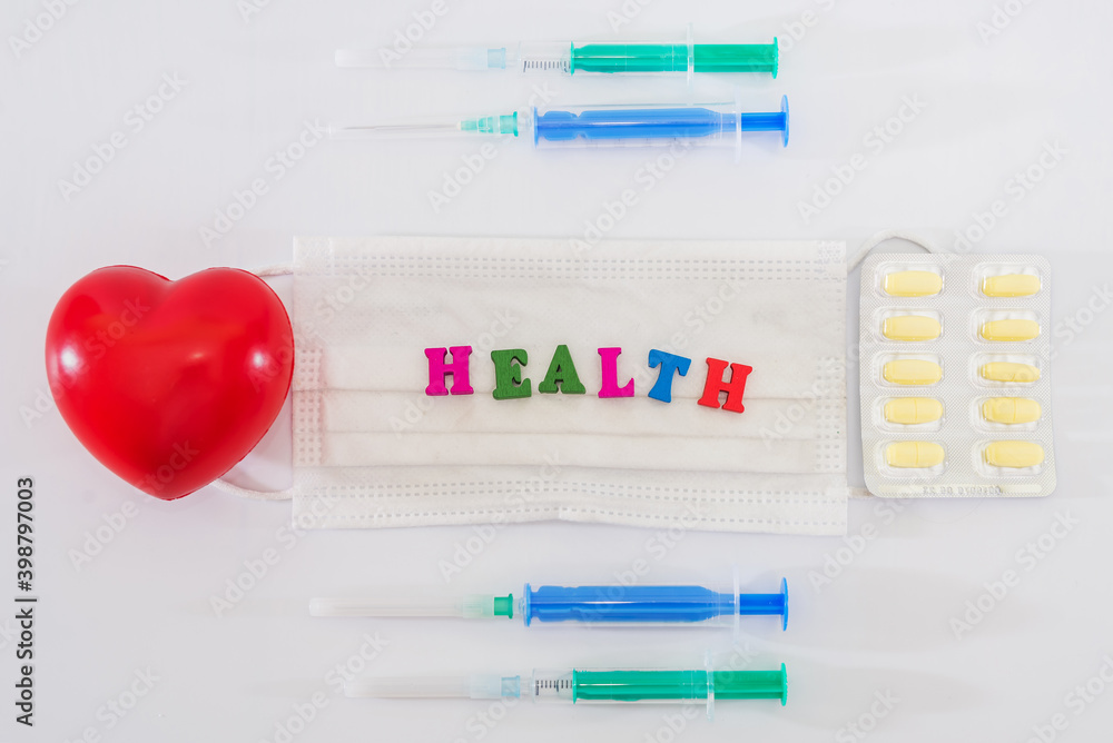 red heart with pills, syringes and different medicines on white. Health concept. red heart with pills, syringes and different medicines on white. Health concept.