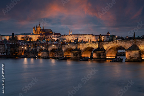 prague castle and charles bridge and st. vita church lights from street lights are reflected on the surface of the vltava river in the center of prague at night in the czech republic © svetjekolem