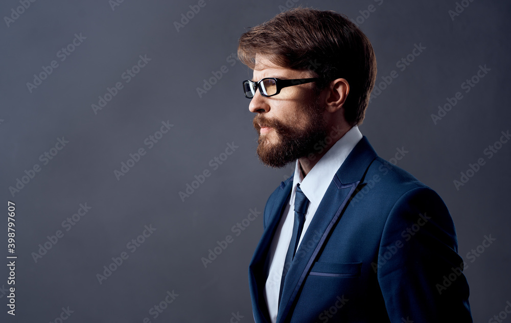 Handsome men in classic suit on a dark background model with glasses cropped view. Handsome men in classic suit on a dark background model with glasses cropped view.