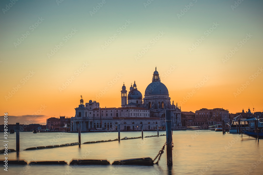Basilica of Santa Maria della Salute in Venice seen at sunset with no one in the Grand Canal due to covid-19