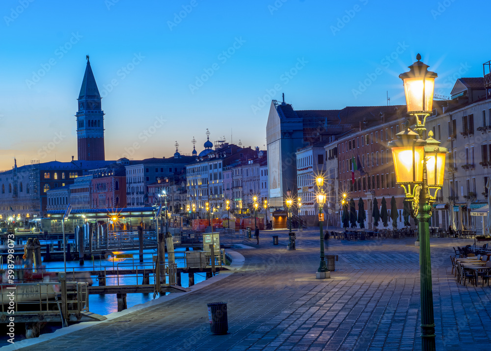 view of St Mark's Square bell tower at sunset with no one in the street due to covid-19