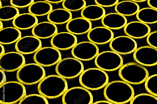Blurred abstract background of yellow cardboard rings. Abstract blurry graphic texture background.