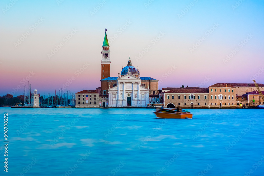 Church of San Giorgio Maggiore at sunset with the canal Grande and the Giudecca canal empty due to the coivid-19