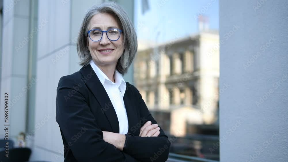 Successful woman lawyer standing with crossed hands, suggesting legal aid Successful woman lawyer standing with crossed hands, suggesting legal aid