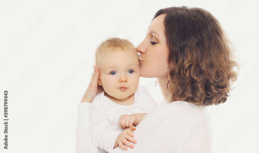 Portrait of happy mother kissing her little baby on a white background Portrait of happy mother kissing her little baby on a white background