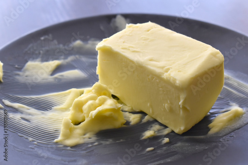Butter on a black plate.  Copy space is on the left side. 