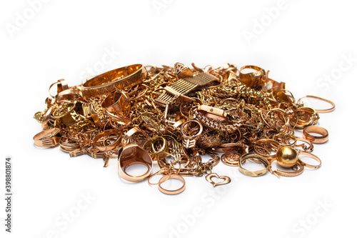 Scrap gold jewelry. Pile of old used gold jewelry on white background.