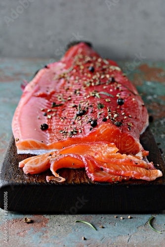 Gravlax, scandinavian beet cured spiced salmon on the board, top view, salted red fish photo