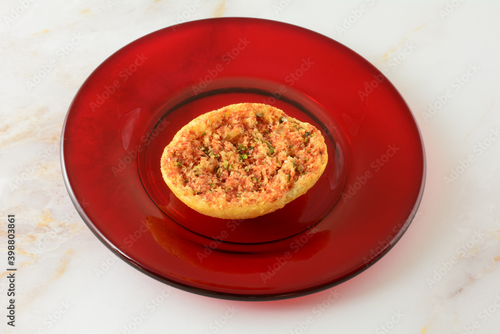 Tomato and oregano bruschetta snack on red glass plate on table