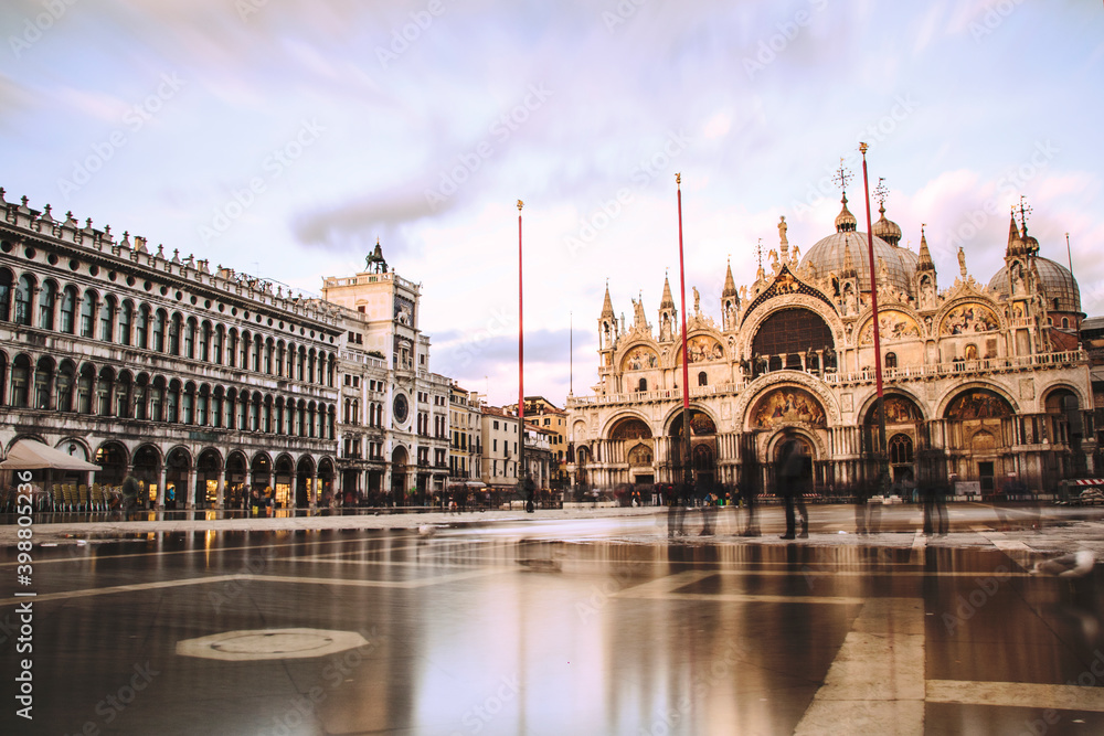 
Piazza San Marco in Venice, during the high water with no people, the square is full of water and the basilica shines in the sun. long exposition