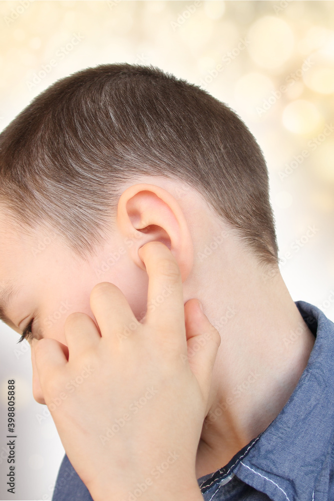 little boy holds on to the ear, part of the face close-up, medical concept, hearing control, middle ear inflammation, otitis media little boy holds on to the ear, part of the face close-up, medical concept, hearing control, middle ear inflammation, otitis media