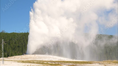 Old Faithful geyser erupting steam and water