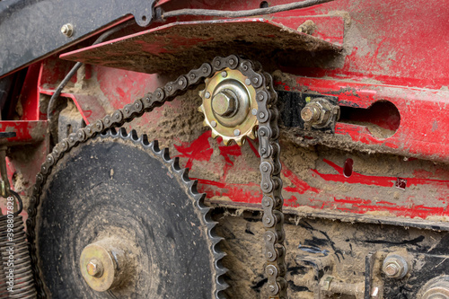 Canvas Print Closeup of combine harvester chain and gear sprocket