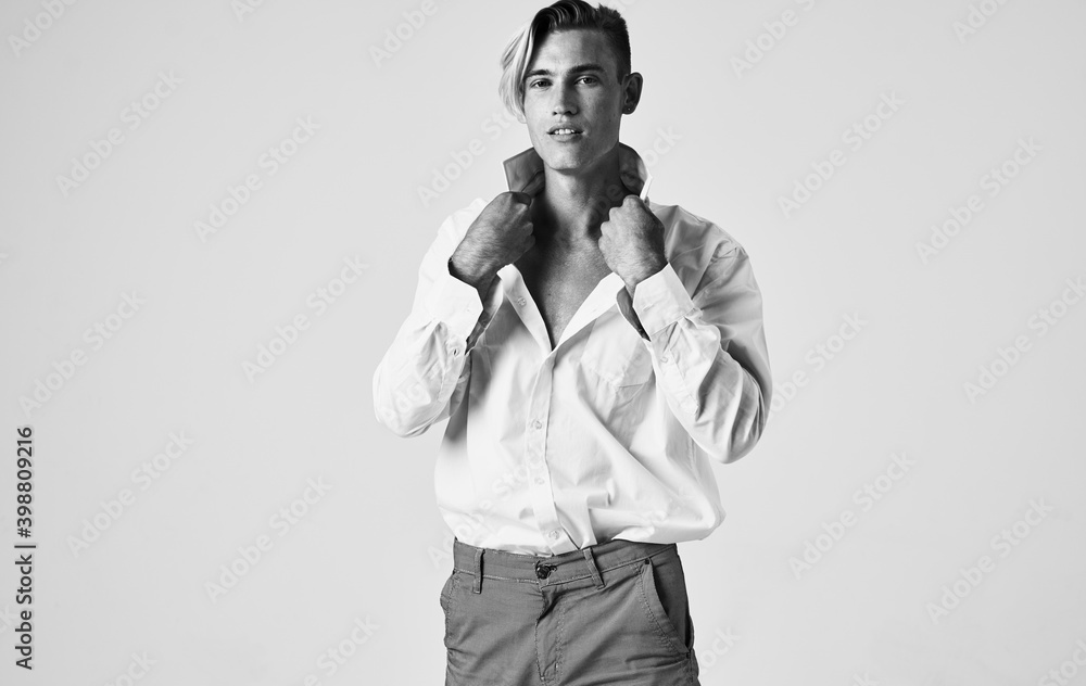 beautiful gentleman in a shirt on a light background gray photograph model